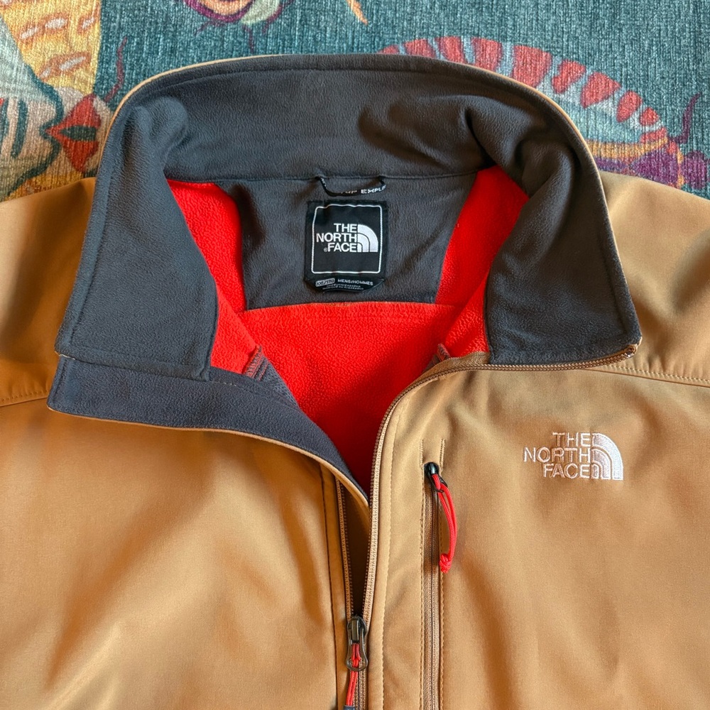 Men’s The North Face Apex Bionic jacket. Tan with orange/red details.